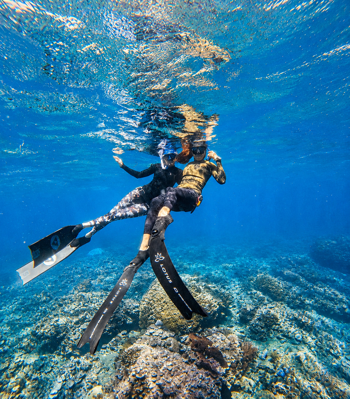 Two female freedivers underwater at a local dive spot in Amed Bali